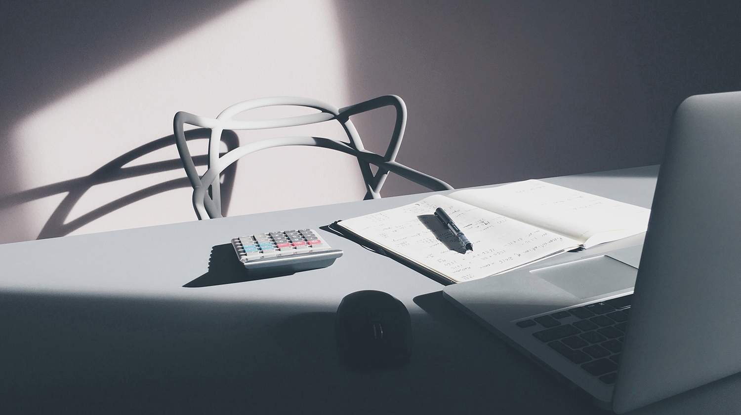  Shadowy Image of Modern and White Computer Chair, Desk and a Laptop